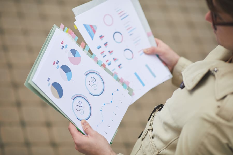 Unrecognizable Businessman Holding Charts Outdoors